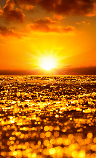 Water rippled surface background with gold yellow sunset reflected