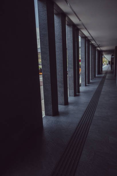istock Corridor of a perfectly symmetrical park with columns on the sides 1816982549
