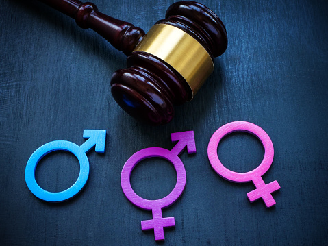 Gender symbols and gavel as a symbol of legislation and equality laws.