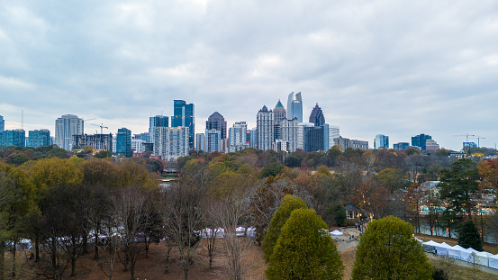 Atlanta, GA: November 24,2023- Panoramic aerial view of Atlanta skyline  and Piedmont park with lake Clara Meer shot during sunset on a overcast day by drone