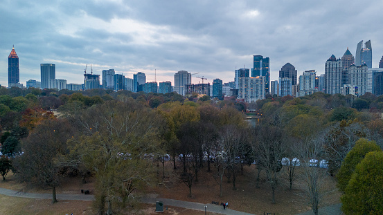 Atlanta, GA: November 24,2023- Panoramic aerial view of Atlanta skyline  and Piedmont park with lake Clara Meer shot during sunset on a overcast day by drone