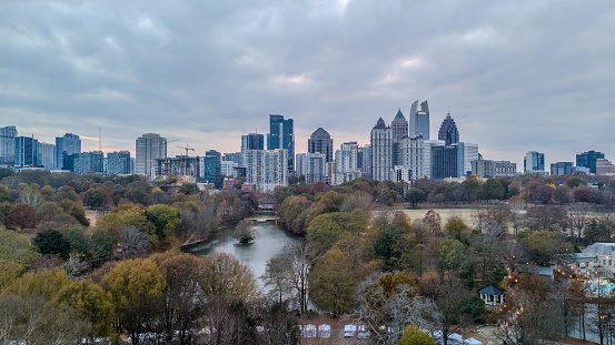Atlanta, GA: November 24,2023- Panoramic aerial view of Atlanta skyline  and Piedmont park with lake Clara Meer shot during sunset on a overcast day by drone