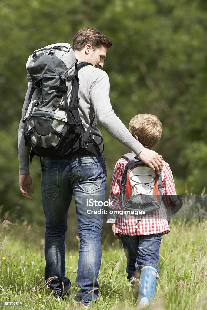 Father And Son Hiking In Countryside Father And Son Hiking In Countryside Smiling To Each Other Child Stock Photo