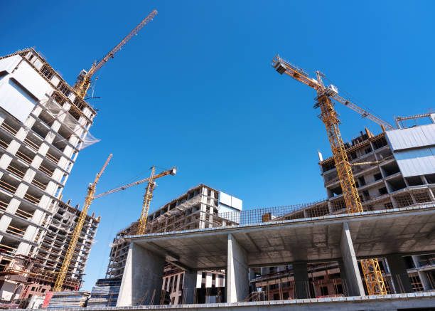istock Lifting cranes at a construction site of new houses. 1817030053