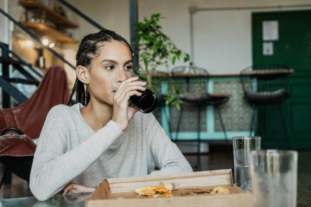 istock Young woman drinking refrigerant at home 1817038532