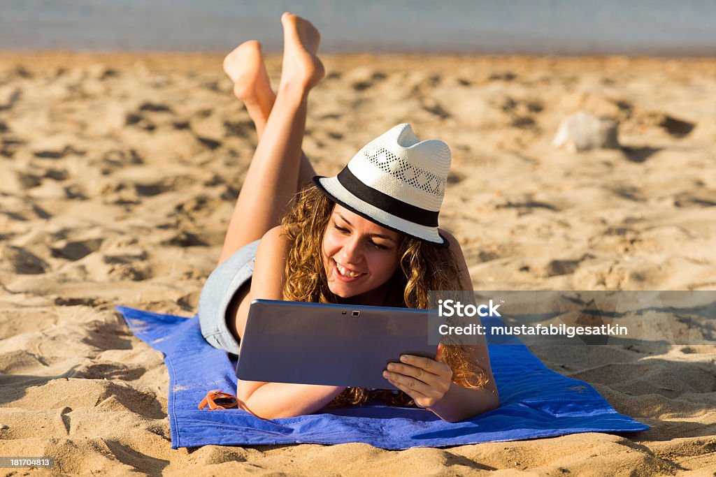 Za pomocą cyfrowego tabletu na plaży. - Zbiór zdjęć royalty-free (Biznes)