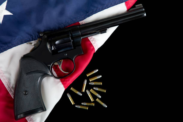 istock 22 Revolver with bullets on American Flag 1817050048