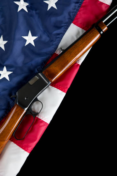 istock Lever action rifle lays on American Flag background 1817050056
