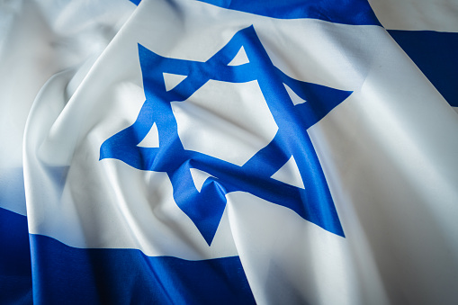 Close-up of Israel national flag, dramatic lighting