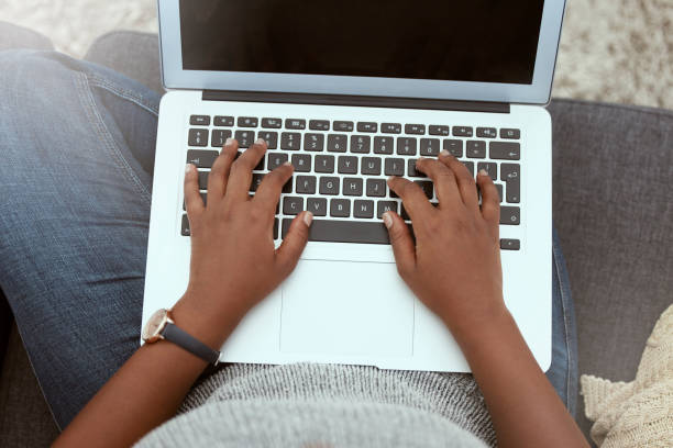 istock Laptop, woman and hands typing on a keyboard while working on a freelance project at her house. Technology, research and closeup of female working on a report with a computer in living room at home. 1817066081