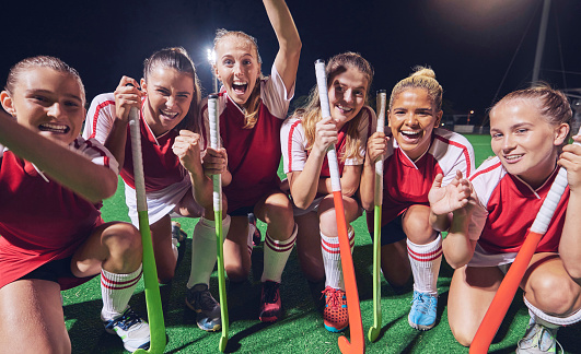 Hockey team, women winner or happy portrait for success, goal or celebration for match, game or competition at night on court. Smile group of girl athlete for training, workout for teamwork exercise