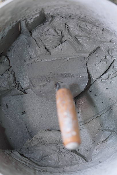 istock Old dirty trowel and bucket on building site 181710170