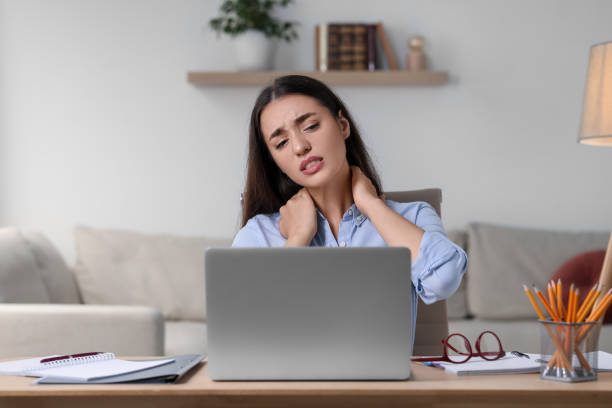 istock Young woman suffering from neck pain at table in office 1817108357