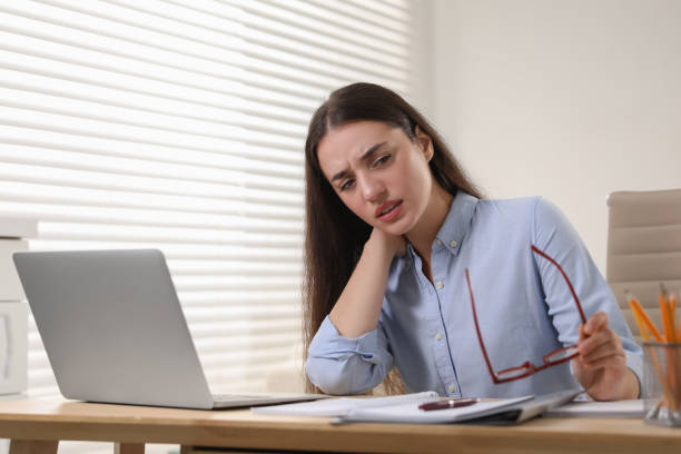 istock Young woman suffering from neck pain at table in office 1817108939