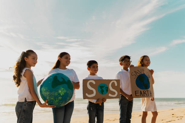 istock Children protesting to save planet Earth on the beach 1817128342