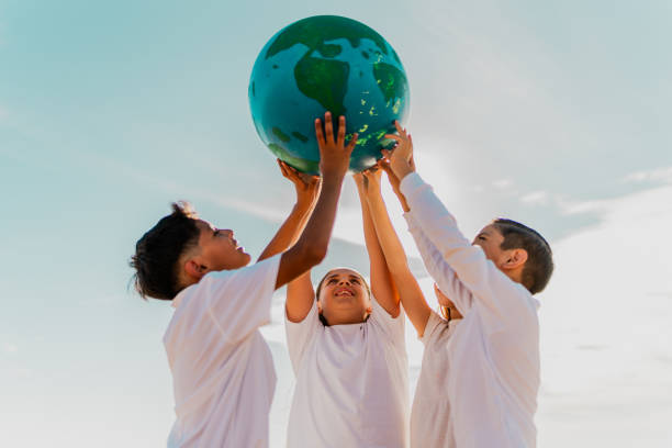 istock Children holding a planet on the beach 1817128859