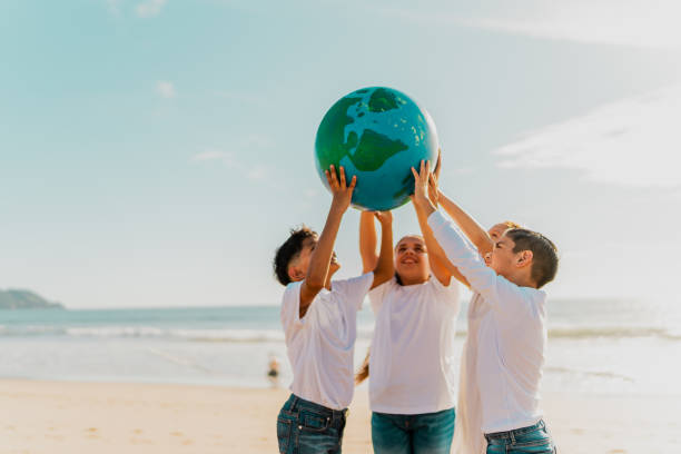 istock Children holding a planet on the beach 1817128870