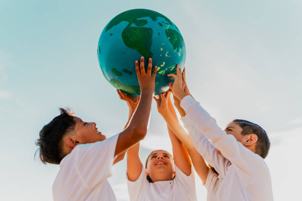 istock Children holding a planet on the beach 1817128873