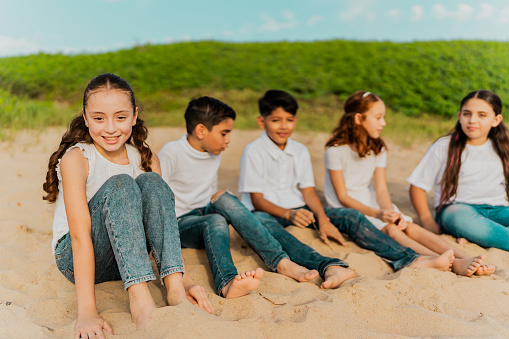 Portrait of a child girl with her friends on the beach