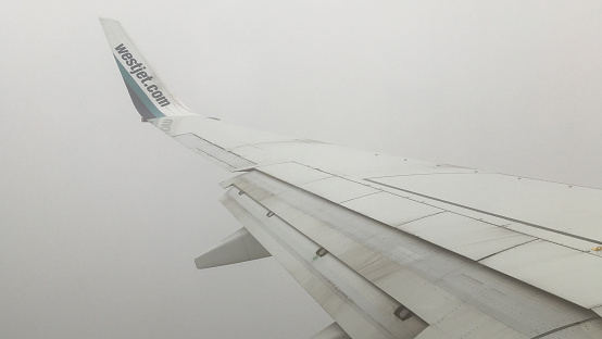 Westjet airplane flying over Ontario near YYZ Toronto airport in Canada.