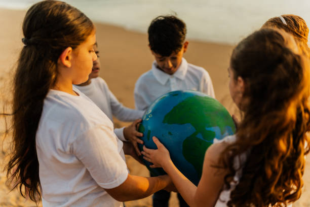 istock Children holding a planet on the beach 1817131041