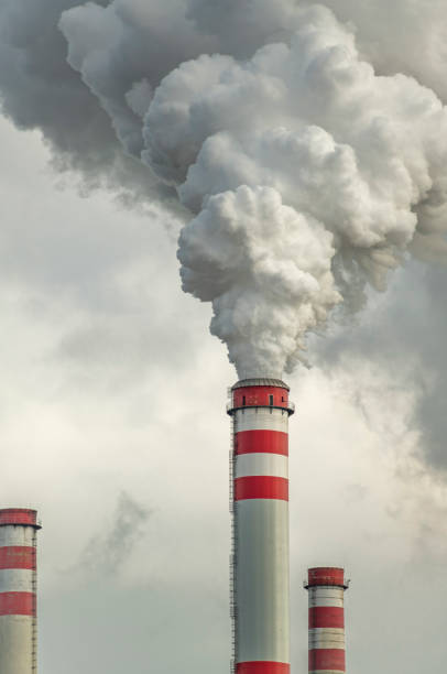 istock White smoke from big red chimneys in cold cloudy autumn day 1817131271