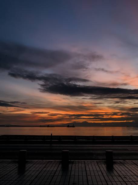 istock a person in a field looking out at a sunset over water 1817136859