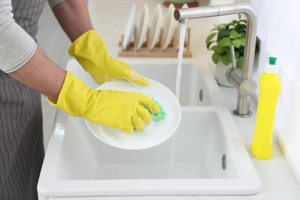istock Man washing plate above sink in kitchen, closeup 1817137935