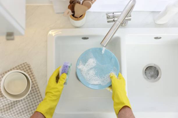 istock Man washing plate in kitchen sink, top view 1817138305