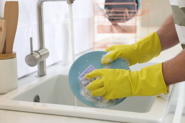 istock Man washing plate above sink in kitchen, closeup 1817138488