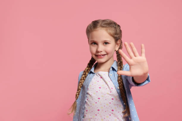 istock Cheerful girl giving high five on pink background, space for text 1817140652
