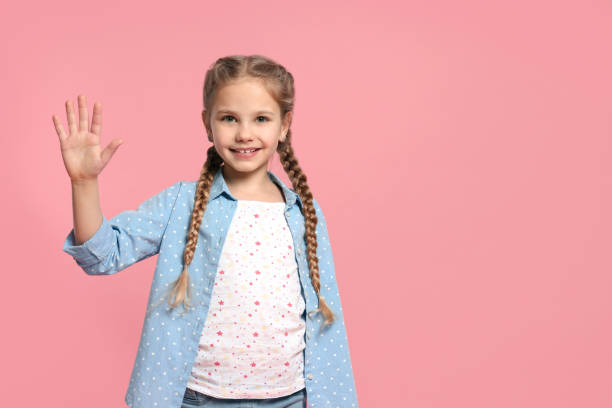 istock Cheerful girl giving high five on pink background, space for text 1817141003