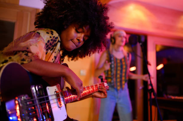 istock A multiracial bass player improvising and jamming in a music studio, recording session. 1817141776