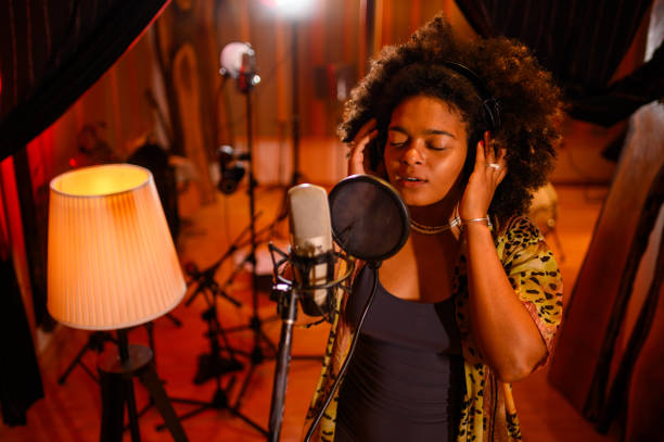 istock Talented young vocalist recording a track in a music studio. 1817142098