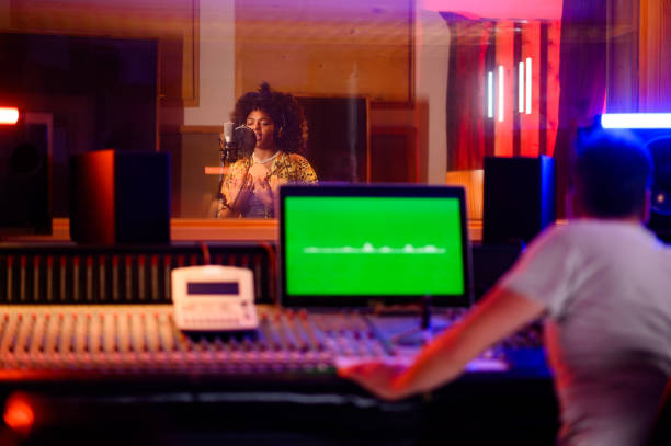 istock Talented multicultural singer recording in vocal isolation booth in music studio. 1817142307
