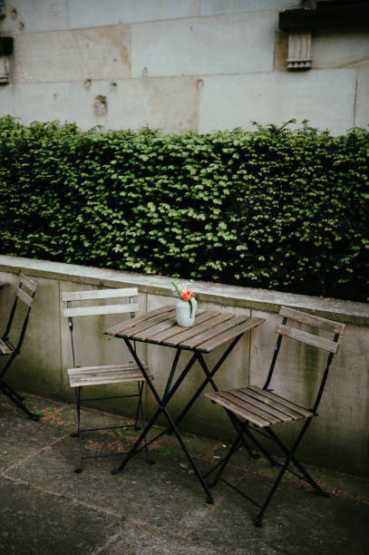 istock Flower vase with tulips on a bistro table and chairs 1817146999
