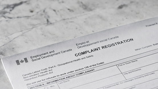 Close up of a Canada Occupational Health and Safety Complaint form with a pen.
