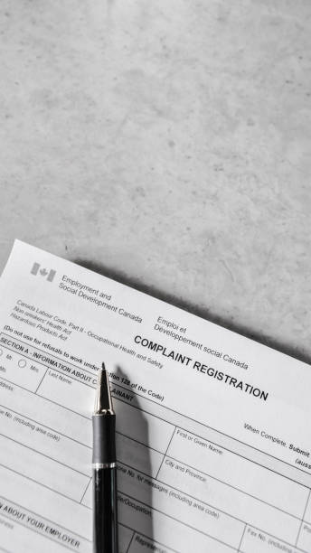 istock Canada Occupational Health and Safety Complaint Form with Pen 1817162004