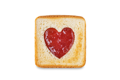 Sweet sandwiches with strawberry jam with heart shape inside for Valentine's day holiday on a white isolated background. toning