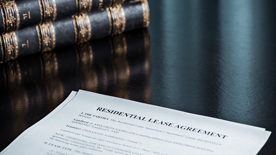 Close up of a residential lease agreement with books.
