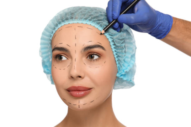 istock Doctor with pencil preparing patient for cosmetic surgery operation on white background, closeup 1817203429