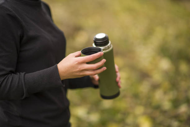 istock Young woman hiking in autumn mountain, sitting, lying down, drinking tea 1817203440