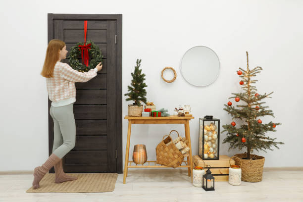 istock Woman decorating her entry way for Christmas 1817216513
