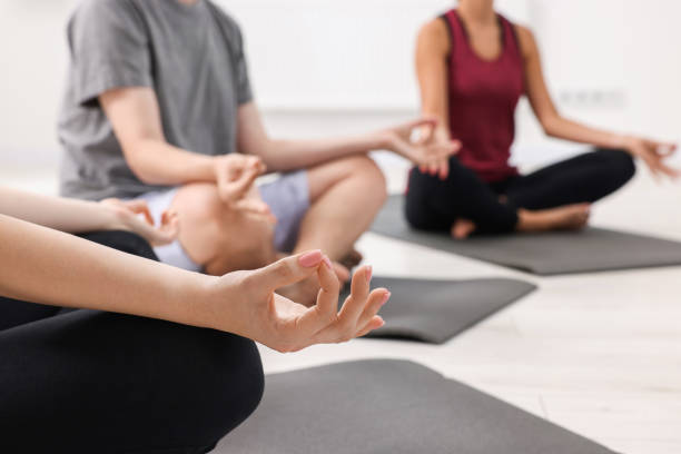istock Group of people practicing yoga on mats indoors, closeup. Space for text 1817219179
