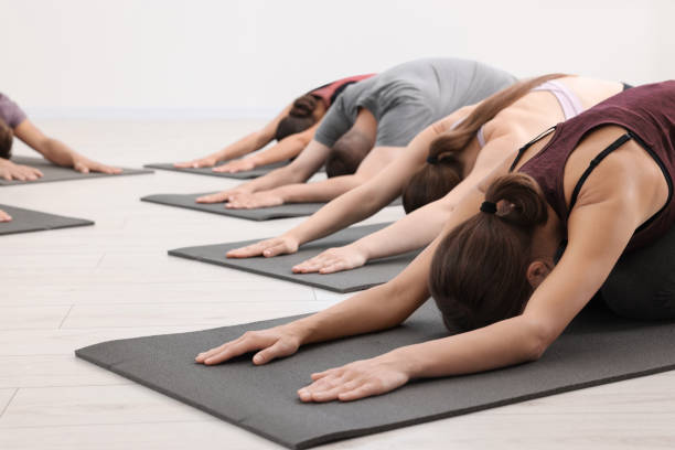 istock Group of people practicing yoga on mats indoors 1817219711