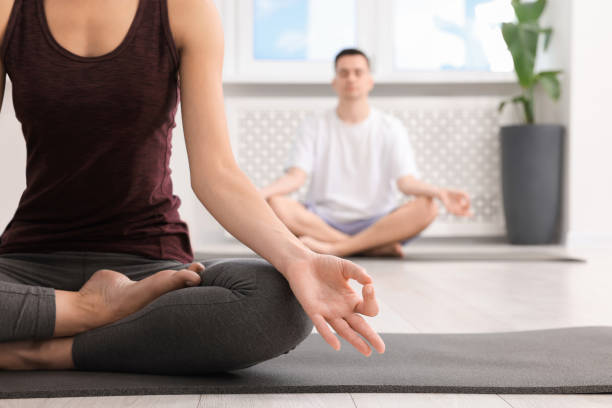istock Woman practicing yoga during group lesson indoors, closeup. Space for text 1817219722