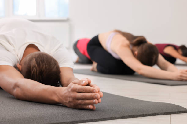 istock Group of people practicing yoga on mats indoors 1817219726