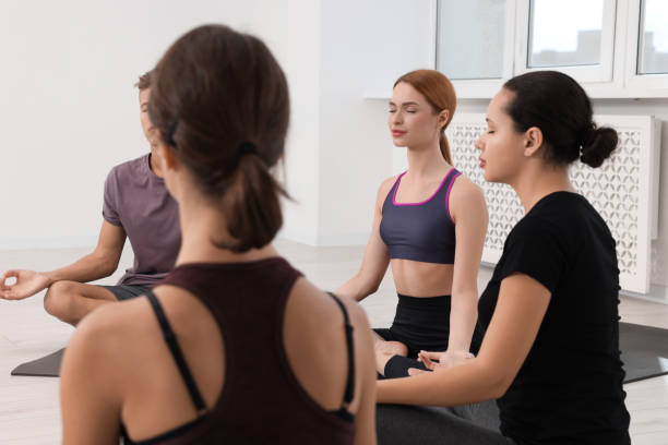 istock Group of people practicing yoga on mats indoors 1817220755