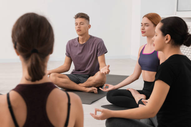 istock Group of people practicing yoga on mats indoors 1817220774
