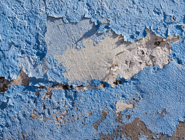 istock Weathered cement wall with peeling paint. Abstract grunge background. Old damaged concrete cement wall with flaking blue paint. 1817250872